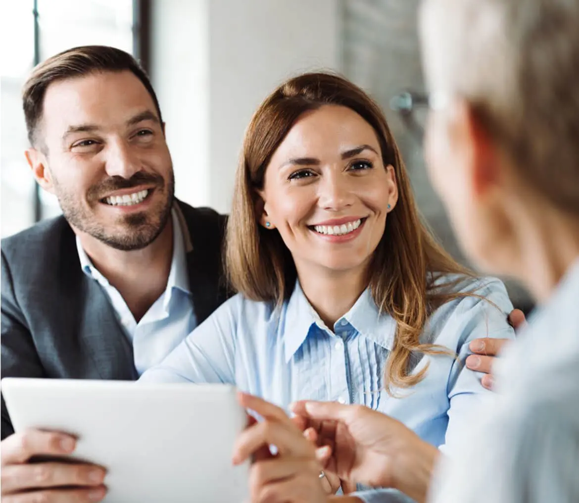 Smiling couple meeting with advisor