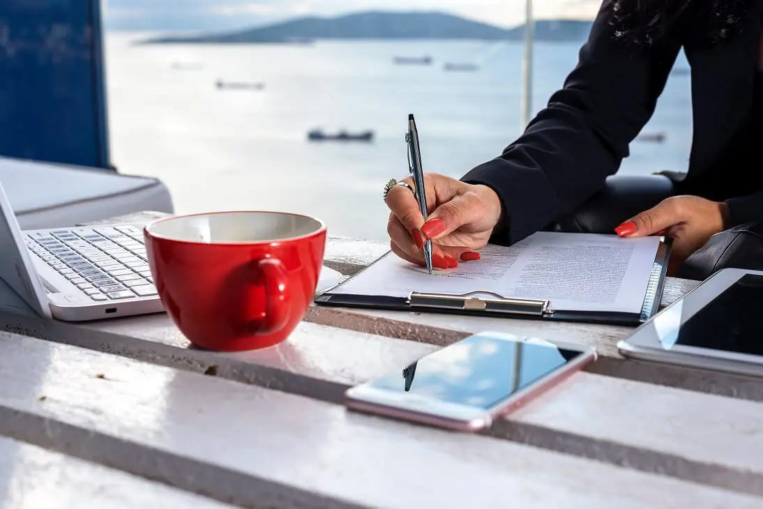 Person writing by the sea