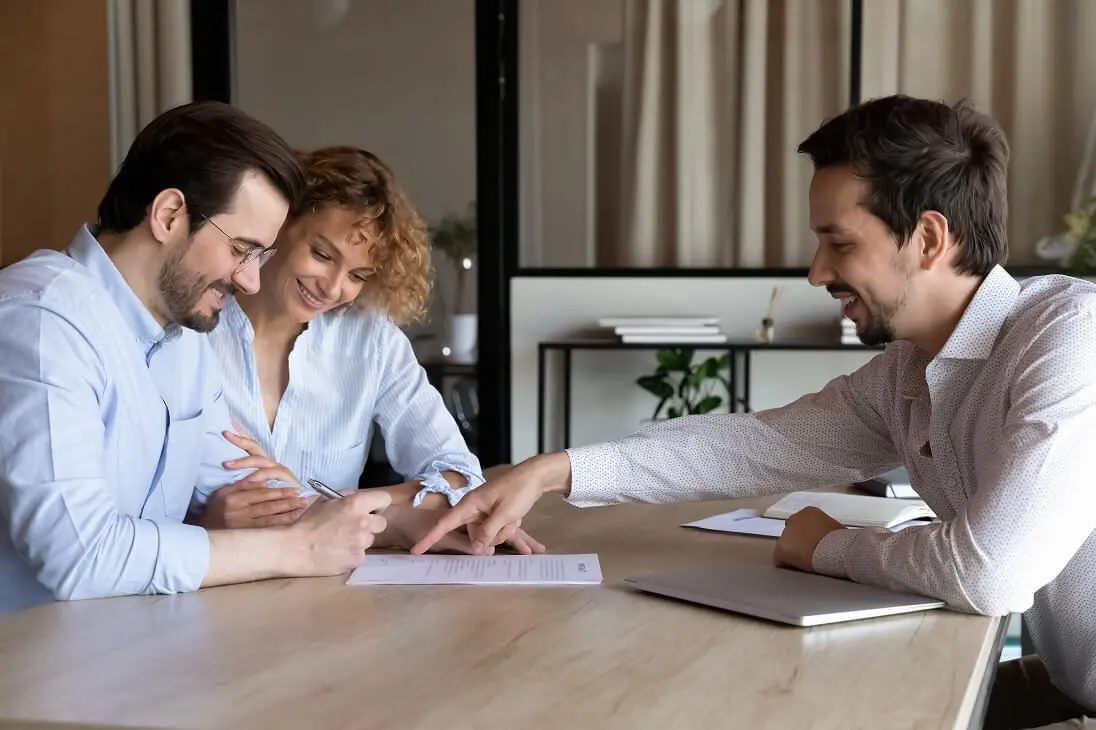 Advisor assisting couple with paperwork