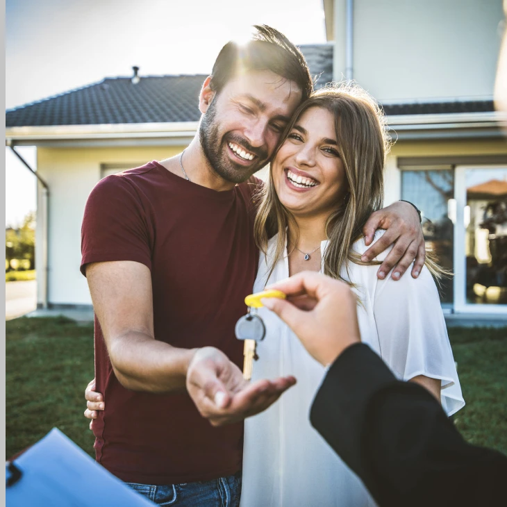 Happy couple getting home keys