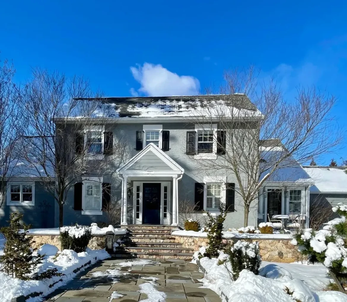 Snow-covered house under clear blue sky