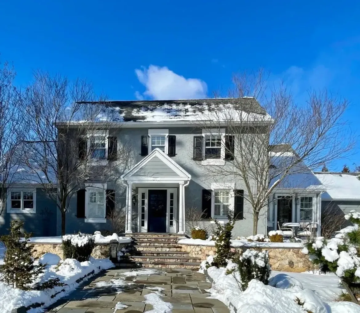 Snow-covered house under clear blue sky